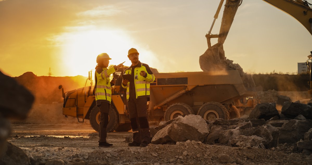 Engineers supervising construction equipment